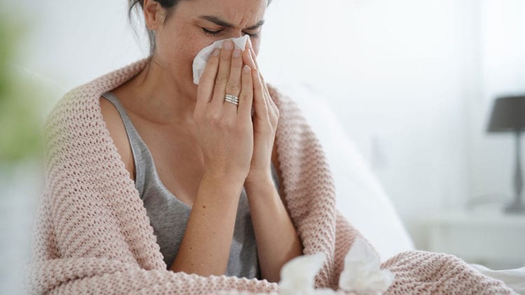 Sick Woman Blowing Nose | Columbia Heating & Cooling